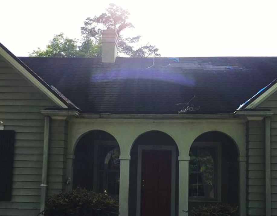before - roof transformation on house with white arches and charcoal roof