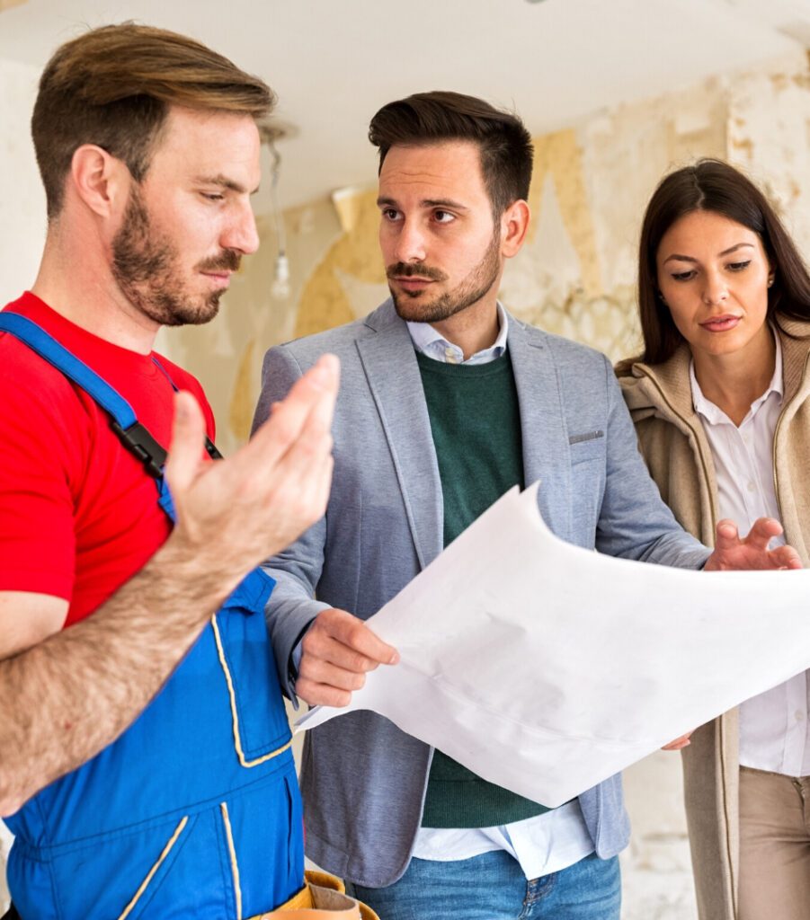 Couple discussing building plans with roofer